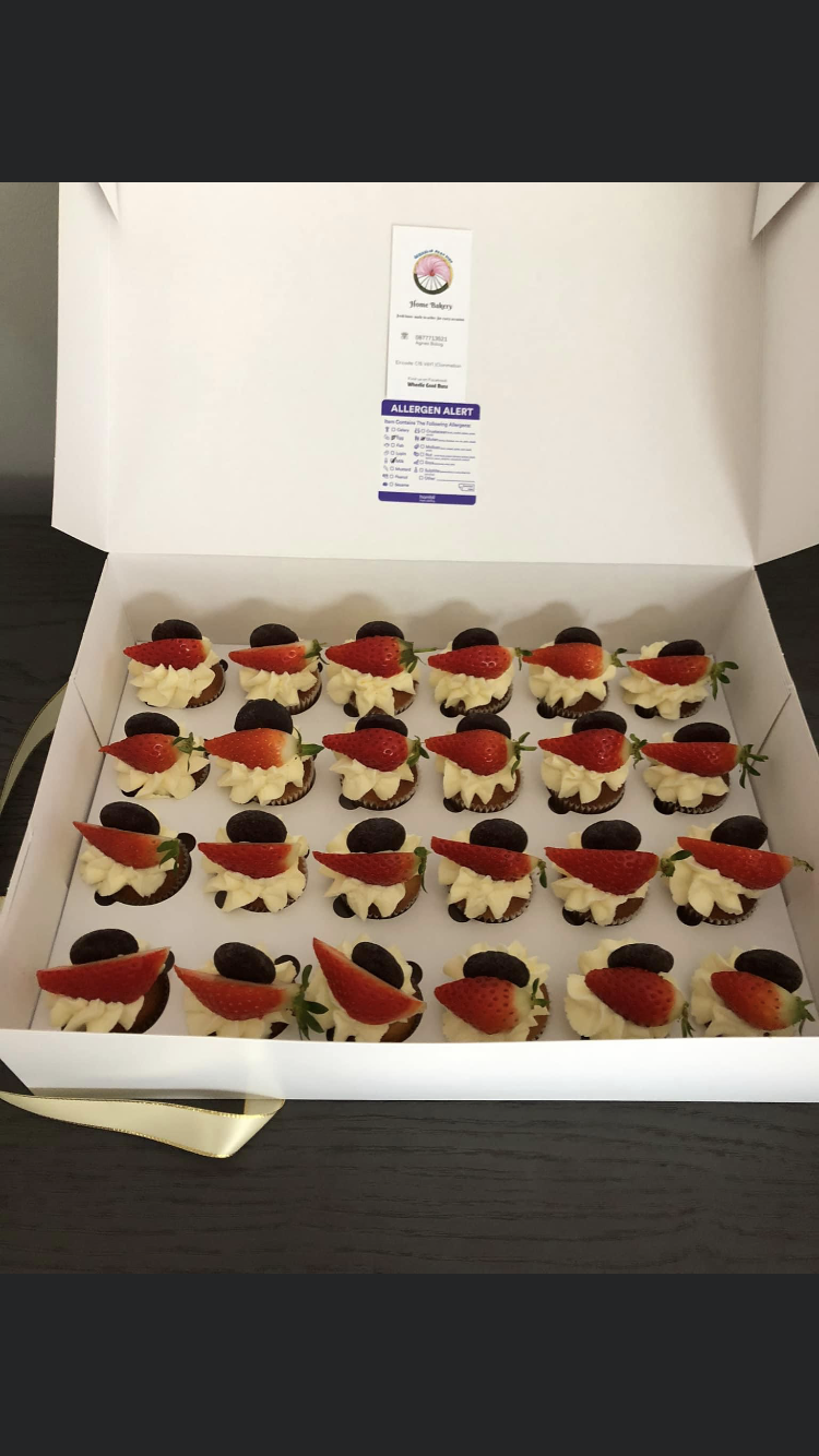 Box of 24 mini chocolate chip cupcakes with cream and strawberries